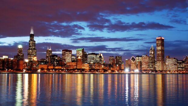 Night cityscape of North America skyline reflected over calm water