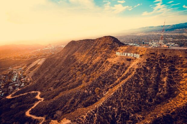 The hollywood sign on a mountain hill in north america during sunset