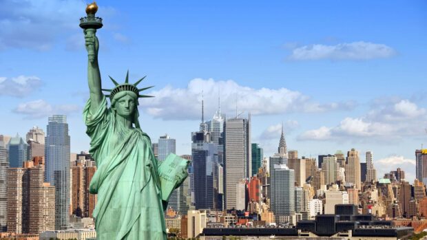 The Statue of Liberty overlooking the New York City skyline on a clear day