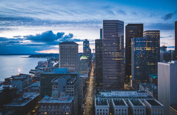 Downtown cityscape in North America during twilight with high rise buildings and waterfront view