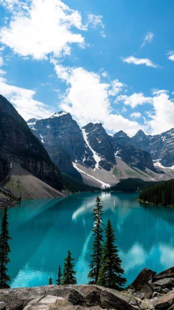 Majestic mountain landscape with turquoise lake and evergreen trees in North America
