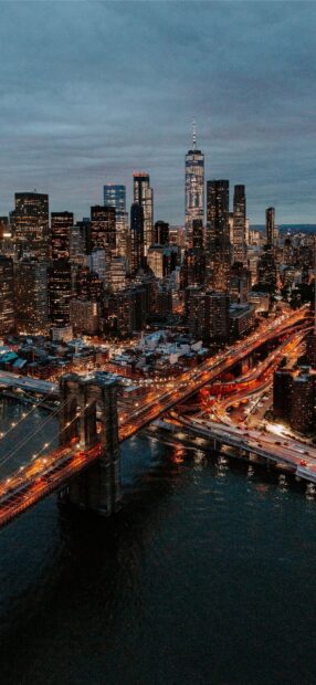 Evening cityscape with North America skyline and illuminated bridge lights