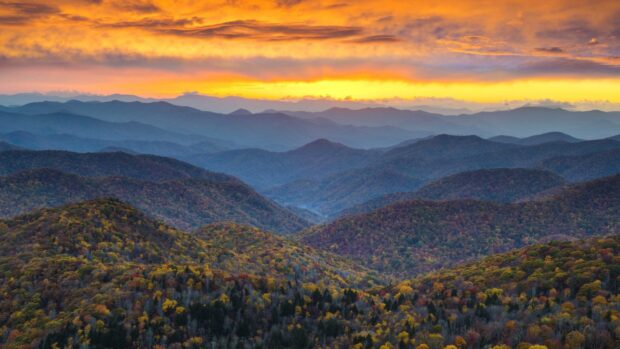Autumn colors cover mountain ranges in North Carolina during a vivid sunset