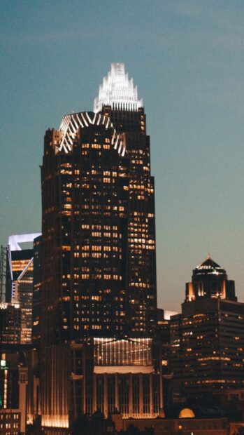 Nighttime view of North Carolina city skyline with illuminated skyscrapers