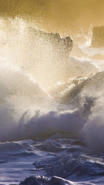 Powerful ocean waves crashing on rocky shore in Oahu