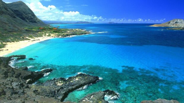 Clear blue ocean waters and rocky coastline of Oahu island Hawaii