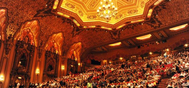 Theater interior in Ohio full of audience with ornate ceiling decorations