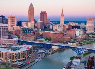Cityscape of Ohio with a blue bridge over the river at sunset