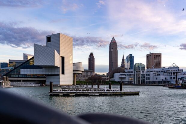 Modern architecture along the waterfront in Ohio skyline at sunset with birds flying