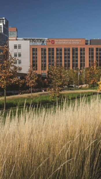 The Ohio State University building with tall grass and trees in Ohio scenery