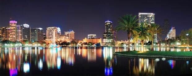 Orlando skyline with illuminated buildings and water reflections at night