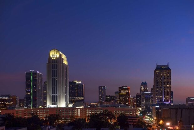 Orlando city skyline at dusk with illuminated skyscrapers and clear evening sky