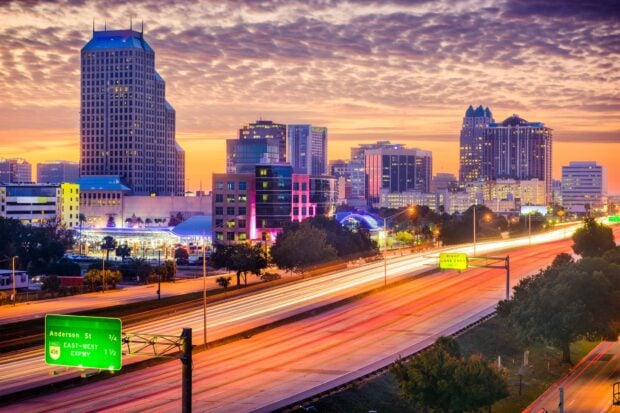 Orlando skyline view with bright city lights and highway at sunset