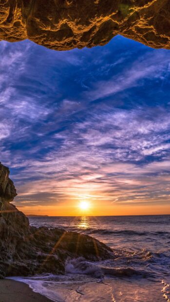 Rocky coast under vibrant sunset sky over the Pacific Ocean