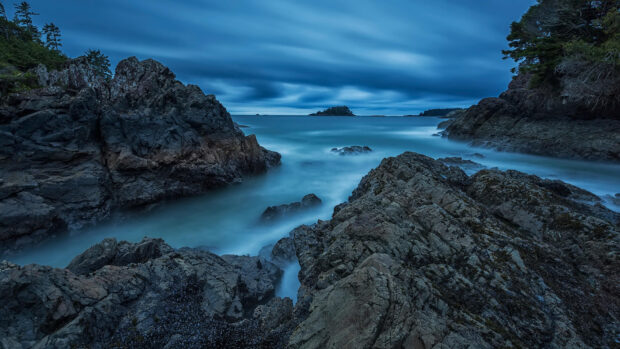 Rocky coastline with Pacific Ocean waves under a cloudy sky