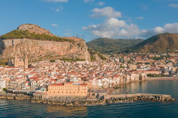A scenic view of Palermo cityscape with rocky hills and Mediterranean coastline