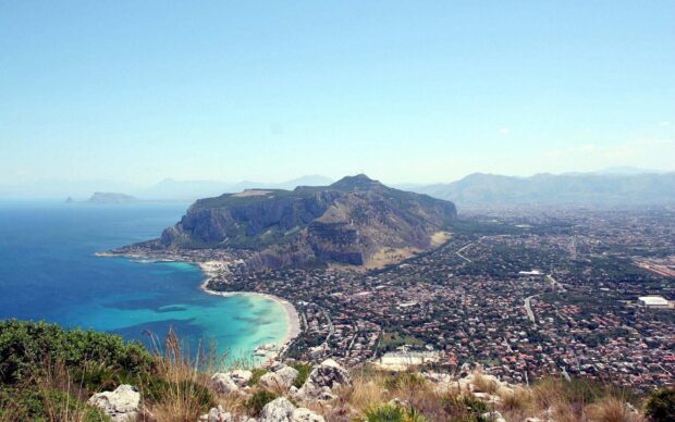 A panoramic view of Palermo city with its coastline and surrounding mountains in clear daylight