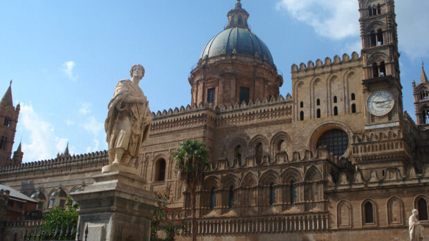 Historic architecture and statue in Palermo with blue sky