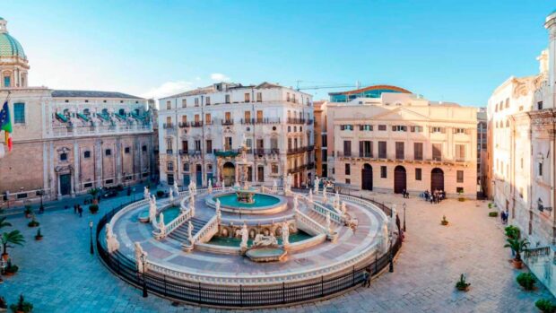 Historic architecture in Palermo with beautiful fountain and clear blue sky