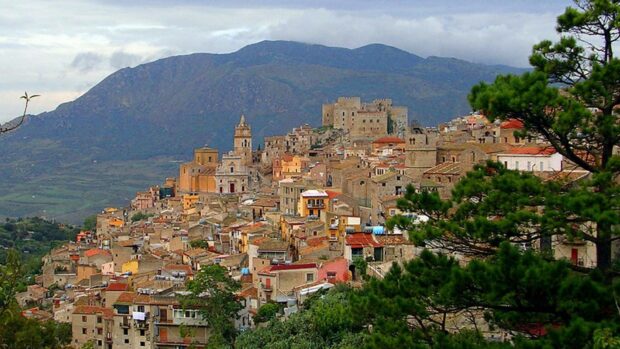 Historic cityscape of Palermo with old buildings and mountain backdrop