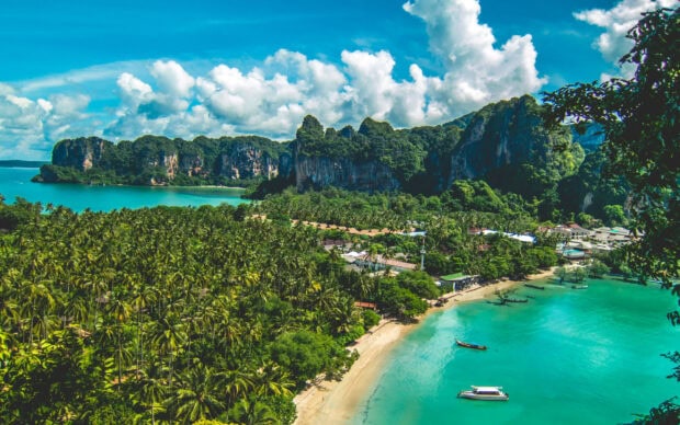 Lush green tropical Phi Phi island landscape with turquoise sea and bright sky