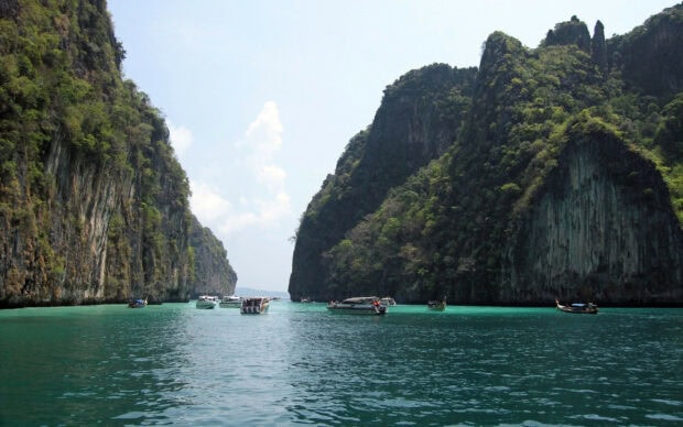 Stunning Phi Phi natural landscape with boats on turquoise water between lush cliffs