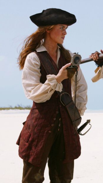 A pirate woman holding a spyglass on a beach in Pirates of the Caribbean