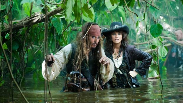 Two pirates exploring a jungle river in Pirates of the Caribbean