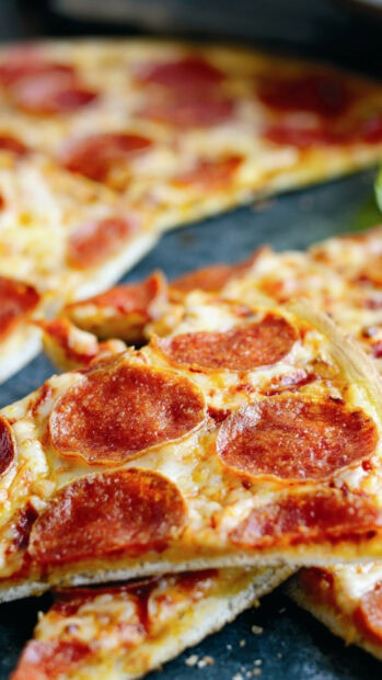 A close up of pepperoni pizza slices with melted cheese on a crispy crust