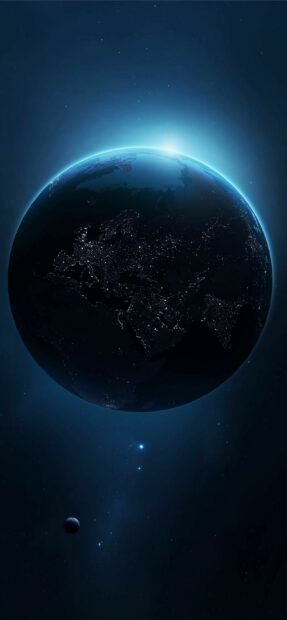 The planet Earth glowing at night with visible city lights and stars in space