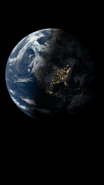 View of planet Earth showing North America with city lights at night and cloud patterns