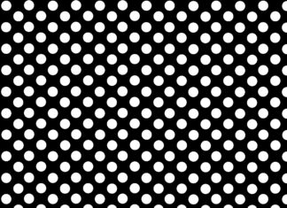 A black polka dot pattern with evenly spaced white dots on a smooth surface
