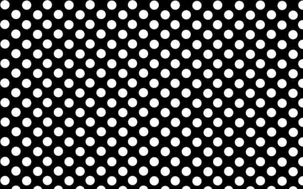 A black polka dot pattern with evenly spaced white dots on a smooth surface