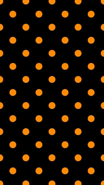 Orange polka dot pattern on a black surface showing polka dot design