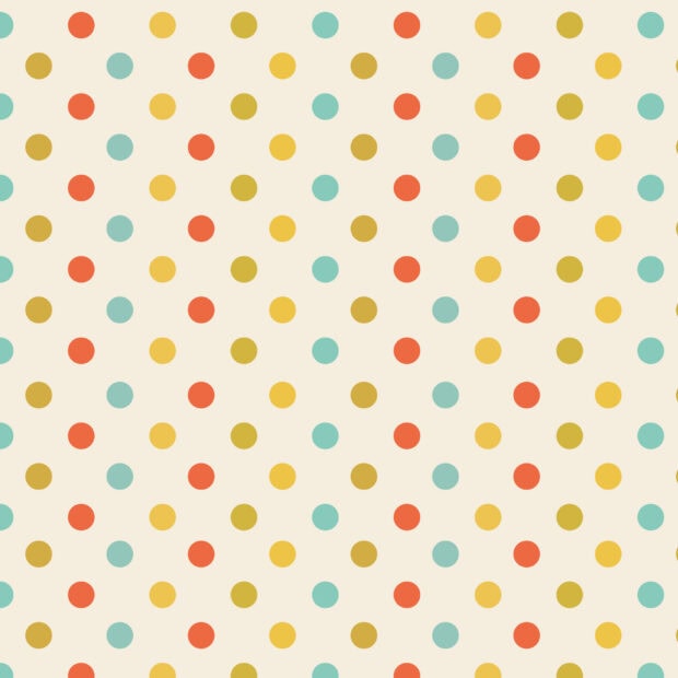Colorful polka dot pattern with red yellow blue and brown dots on a cream background