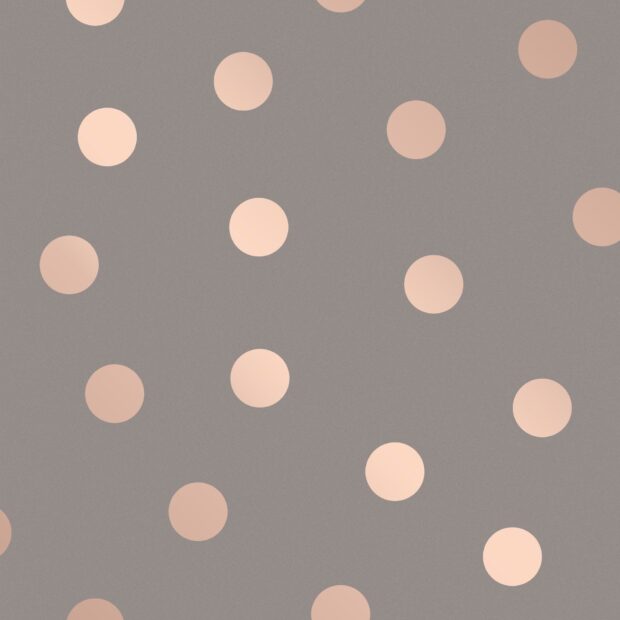 Soft beige polka dot pattern on a muted gray surface with round dots