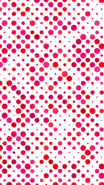 A colorful polka dot pattern with various shades of red and pink on a white background