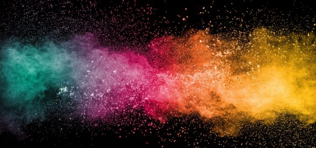 Colorful powder explosion in vibrant hues spread across black background