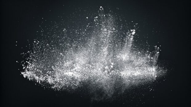 White powder explosion captured against a dark background powder