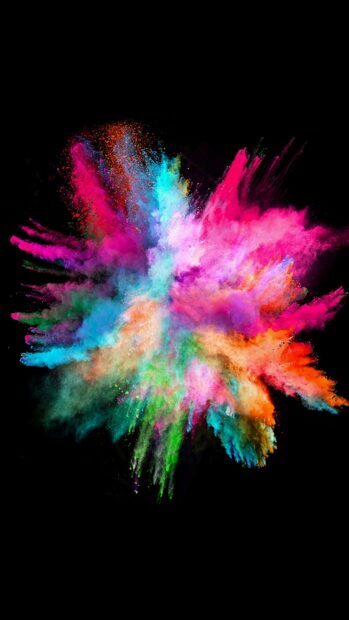 Vibrant colorful powder explosion with bright hues of pink blue green and orange on black background