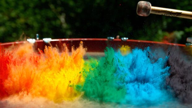 Colorful powder burst with red yellow green and blue powder forming vibrant explosion