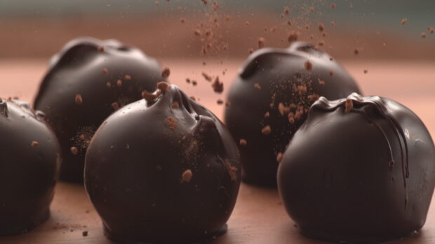 Dark powder covering chocolate truffles in close up shot