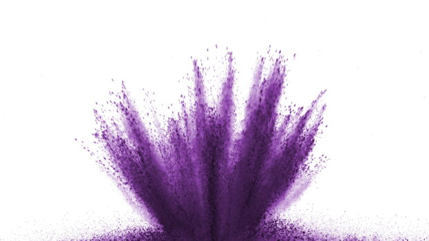 Purple powder burst spreading upwards in an abstract artistic display