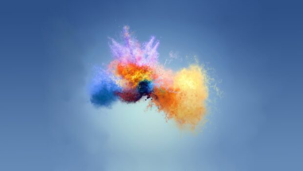 Colorful powder burst with blue orange and purple tones on a blue gradient background