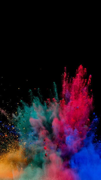 Vibrant colorful powder explosion in motion on a black background