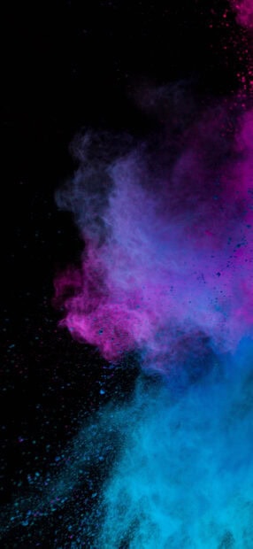 Vibrant powder explosion in blue and purple colors on black background