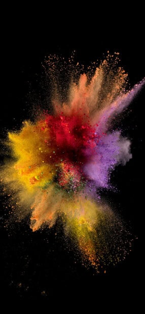 Vibrant powder explosion with red yellow and purple colors on black background
