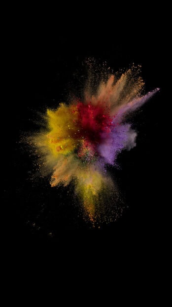 Vibrant colored powder explosion with red yellow and purple powders