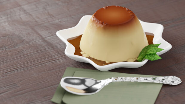 A creamy pudding dessert with caramel sauce served on a white star shaped plate