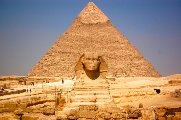 The Great Sphinx of Giza in front of a pyramid at the ancient Egyptian site